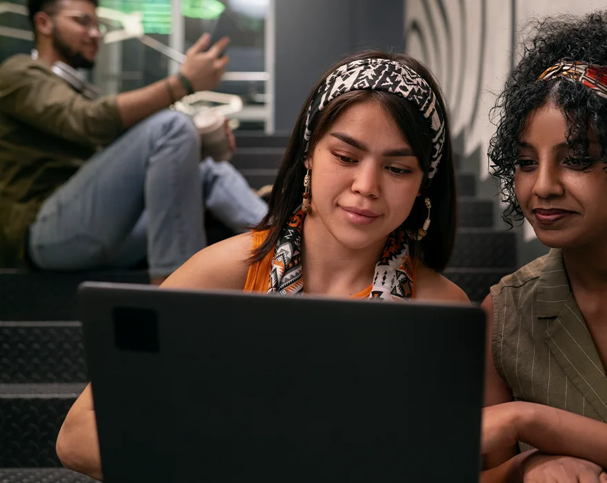 two multi-cultural women working on the computer
